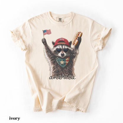 Comfort Colors® America Raccoon Hot Dog Shirt, Kids 4th of July Raccoon Shirt, Patriotic American Flag Tee, Women's Retro USA Animal T-Shirt
